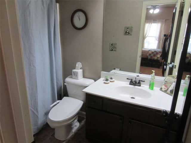 ensuite bathroom featuring vanity, toilet, and ensuite bathroom