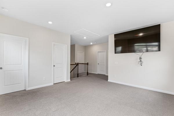 1494 Weeping Tree Cir, Auburn, GA 30548 - unfurnished living room featuring attic access, carpet, and recessed lighting