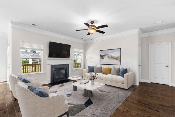 1494 Weeping Tree Cir, Auburn, GA 30548 - living area featuring wood finished floors, a ceiling fan, crown molding, and a glass covered fireplace