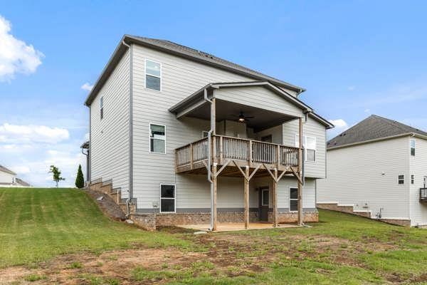 1494 Weeping Tree Cir, Auburn, GA 30548 - rear view of house featuring a ceiling fan, a lawn, and a patio area