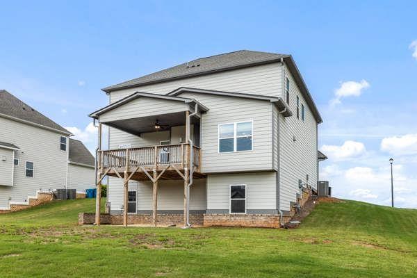 1494 Weeping Tree Cir, Auburn, GA 30548 - back of house with a balcony and a lawn