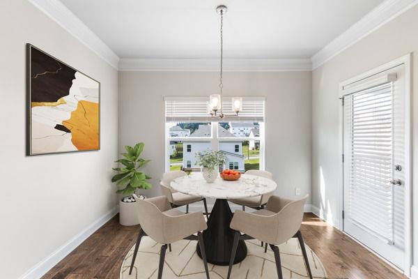 1494 Weeping Tree Cir, Auburn, GA 30548 - dining space featuring a chandelier, ornamental molding, plenty of natural light, and wood finished floors