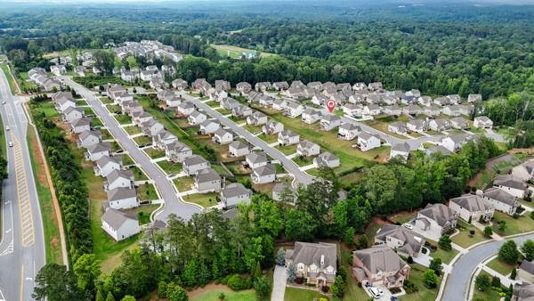 1494 Weeping Tree Cir, Auburn, GA 30548 - aerial overview of property's location featuring nearby suburban area and a forest