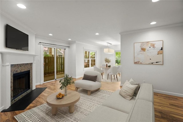 1384 N Crossing Dr NE, Atlanta, GA 30329 - living area featuring healthy amount of natural light, crown molding, a tiled fireplace, wood finished floors, and recessed lighting