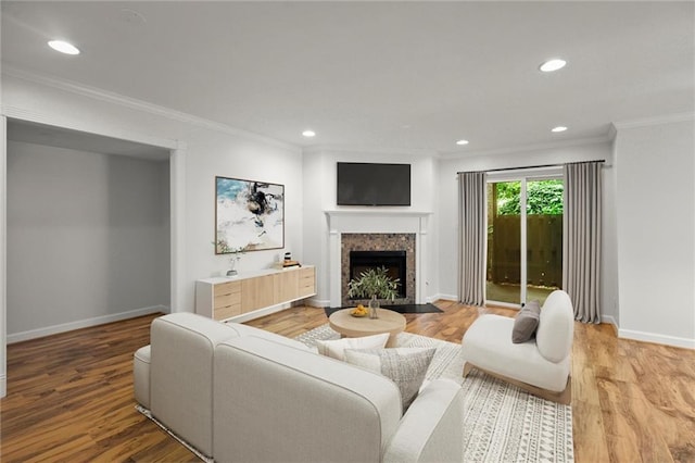 1384 N Crossing Dr NE, Atlanta, GA 30329 - living room featuring crown molding, a tile fireplace, light wood-type flooring, and recessed lighting