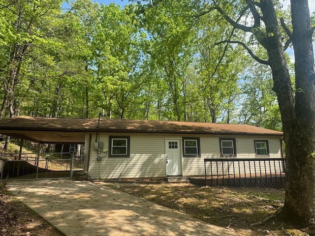 725 Bearmeat Spur, Hiawassee, GA 30546 - view of front facade featuring an attached carport, a deck, and concrete driveway
