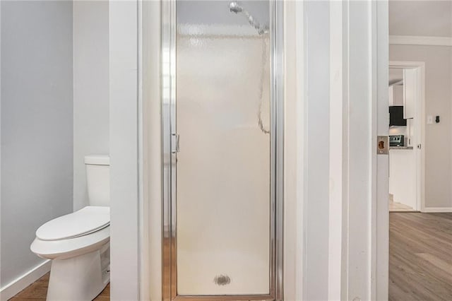 725 Bearmeat Spur, Hiawassee, GA 30546 - bathroom with wood finished floors, ornamental molding, a stall shower, and toilet