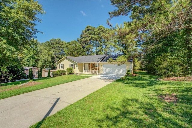 ranch-style home with a garage, a front yard, and concrete driveway