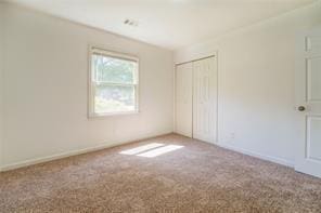 spare room with carpet floors and baseboards