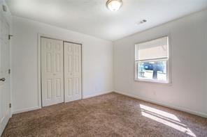 unfurnished bedroom with a closet, carpet flooring, and baseboards