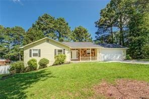 ranch-style house featuring a garage, a front lawn, and a porch