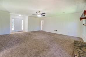 unfurnished living room with carpet and a ceiling fan