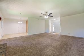 unfurnished living room featuring carpet floors and a ceiling fan