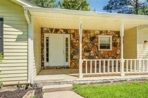 doorway to property featuring a porch