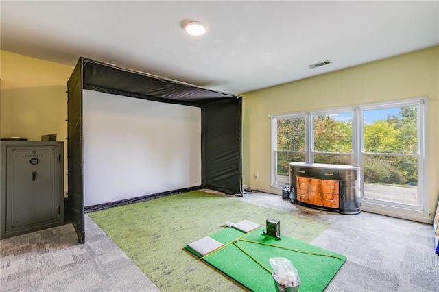 recreation room with golf simulator, visible vents, and carpet floors