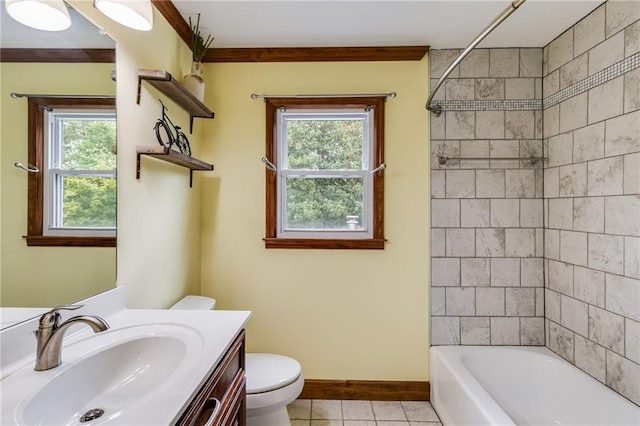 full bathroom with tile patterned flooring, toilet, vanity, baseboards, and shower / washtub combination