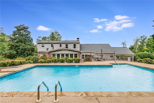 community pool with a patio area