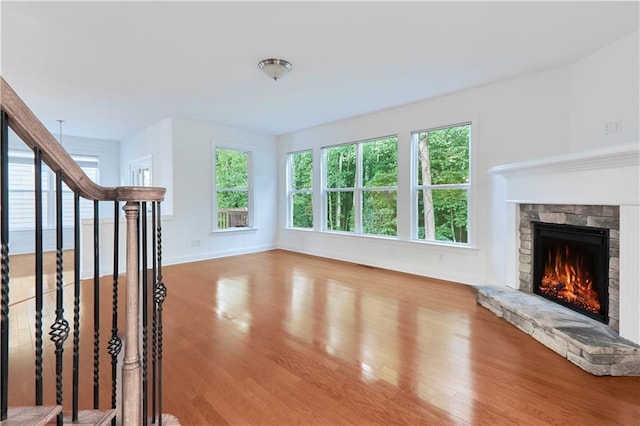 unfurnished living room featuring hardwood / wood-style floors and a fireplace