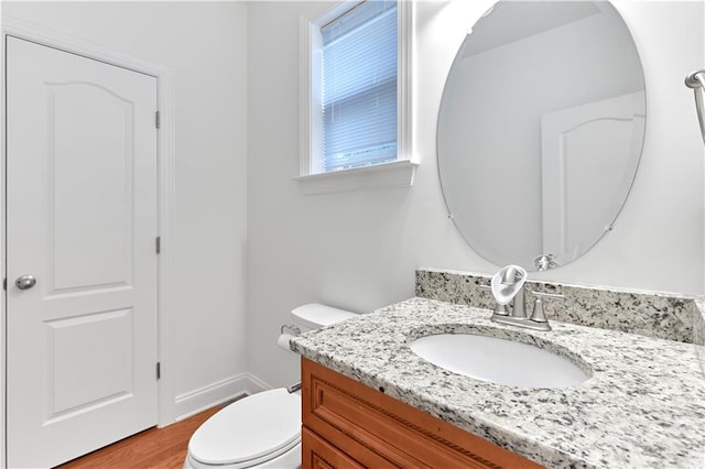 bathroom featuring hardwood / wood-style floors, vanity, and toilet