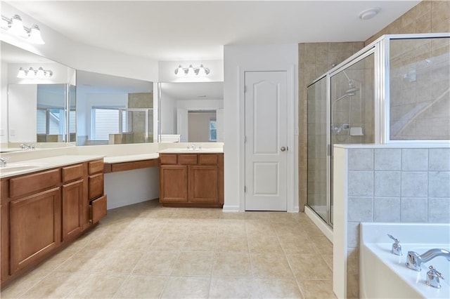 bathroom with tile patterned floors, vanity, and shower with separate bathtub