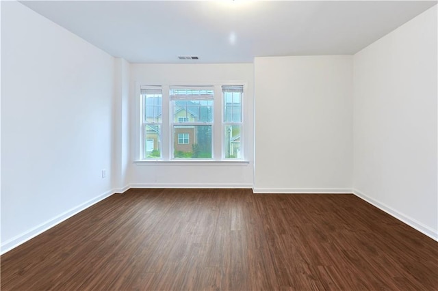 unfurnished room with dark hardwood / wood-style floors