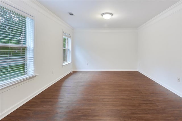 spare room featuring crown molding and dark wood-type flooring