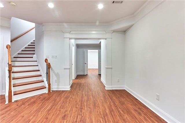 corridor featuring hardwood / wood-style flooring and crown molding