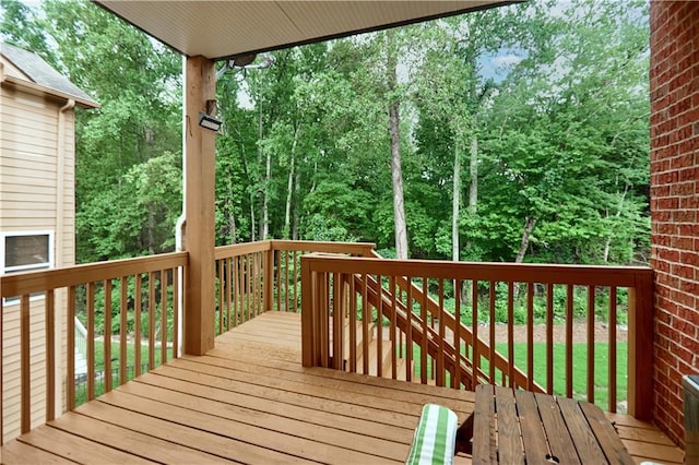 wooden terrace with a yard