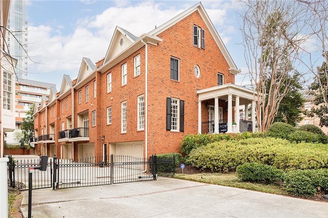 view of property featuring a garage, driveway, and fence