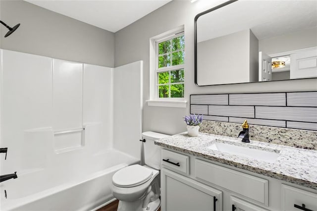 bathroom with toilet, shower / bath combination, and vanity