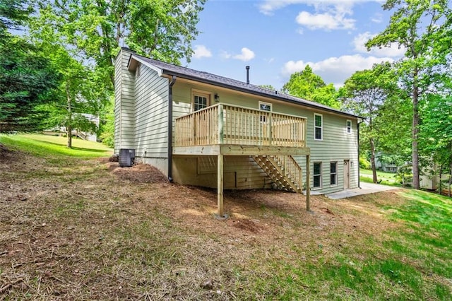 back of house with a deck, stairway, a chimney, cooling unit, and a yard