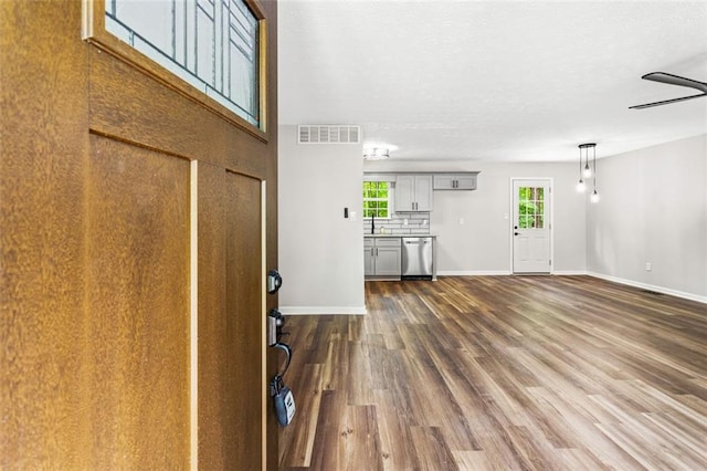 entrance foyer featuring dark wood-style flooring and baseboards