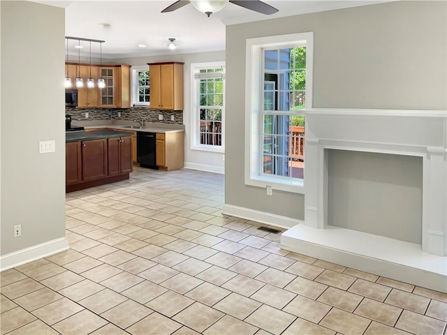 kitchen featuring hanging light fixtures, light tile patterned floors, decorative backsplash, and ceiling fan