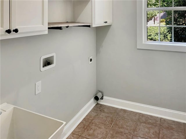 laundry room with hookup for a washing machine, hookup for an electric dryer, cabinets, and tile patterned floors