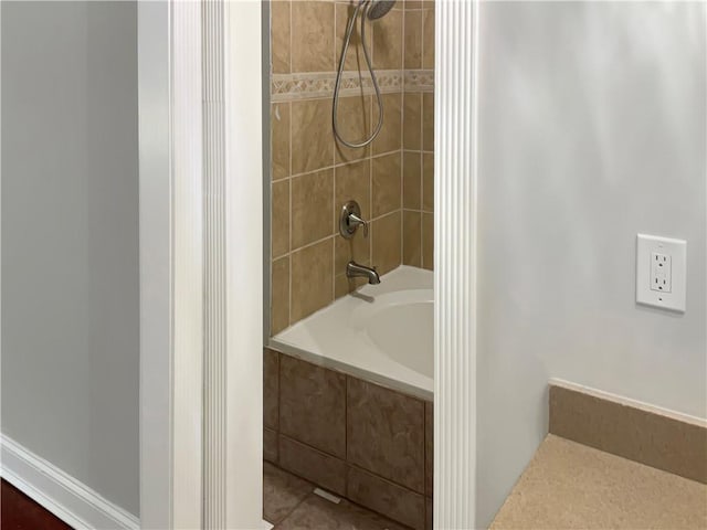 bathroom featuring tiled shower / bath combo and tile patterned floors