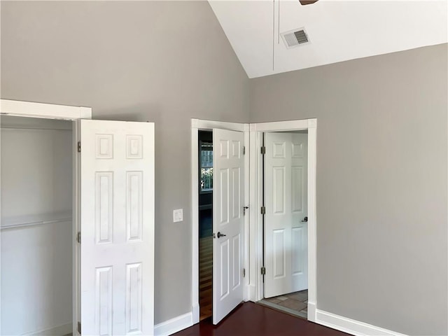 unfurnished bedroom with vaulted ceiling, hardwood / wood-style floors, and ceiling fan