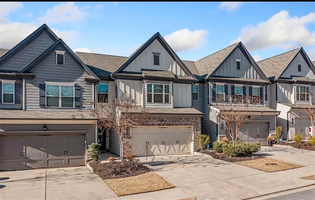 5634 Parkview Ln, Flowery Branch, GA 30542 - townhome / multi-family property with an attached garage, board and batten siding, concrete driveway, and brick siding