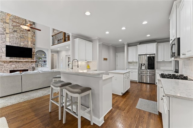 3560 Greenside Ct, Dacula, GA 30019 - kitchen with appliances with stainless steel finishes, a ceiling fan, recessed lighting, a peninsula, and white cabinets