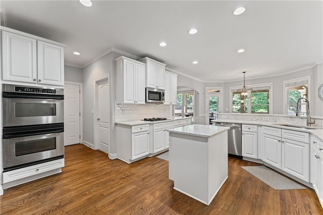 3560 Greenside Ct, Dacula, GA 30019 - kitchen featuring appliances with stainless steel finishes, crown molding, arched walkways, dark wood finished floors, and white cabinets