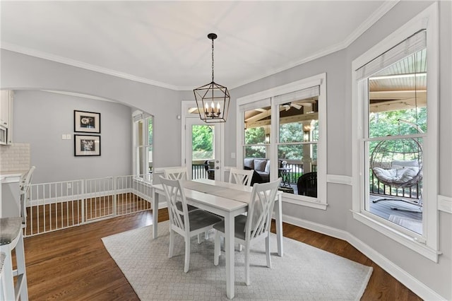 3560 Greenside Ct, Dacula, GA 30019 - dining space with plenty of natural light, arched walkways, dark wood-style flooring, and ornamental molding
