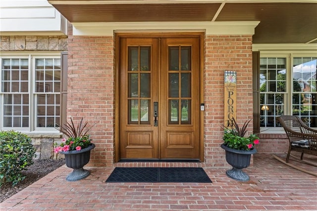 3560 Greenside Ct, Dacula, GA 30019 - property entrance with french doors, covered porch, and brick siding