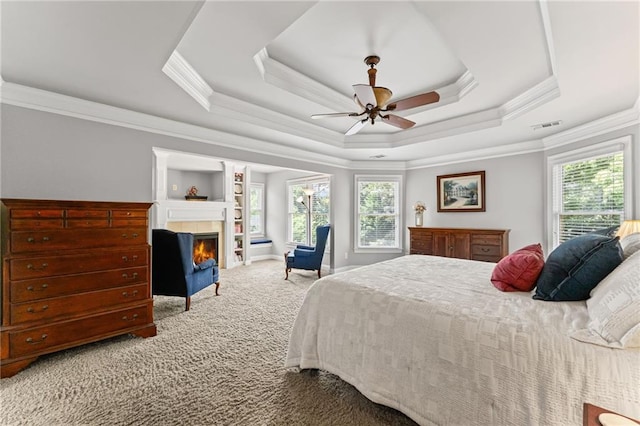 3560 Greenside Ct, Dacula, GA 30019 - bedroom with carpet flooring, a tray ceiling, crown molding, a fireplace, and a ceiling fan