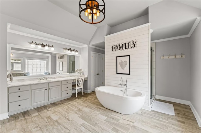 3560 Greenside Ct, Dacula, GA 30019 - bathroom featuring a freestanding tub, vanity, lofted ceiling, a stall shower, and crown molding