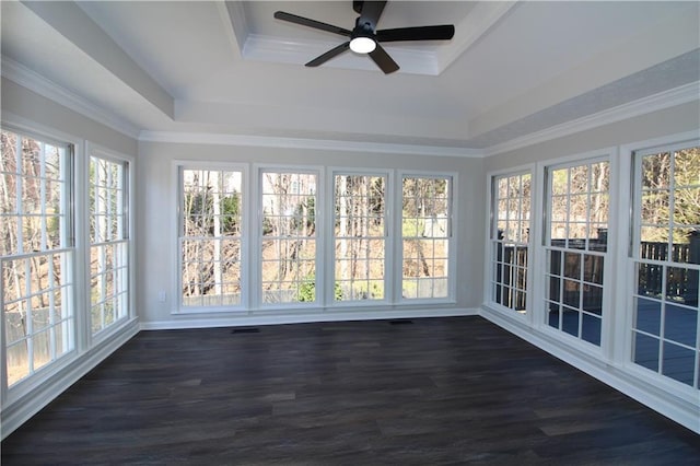 unfurnished sunroom with ceiling fan, plenty of natural light, and a raised ceiling