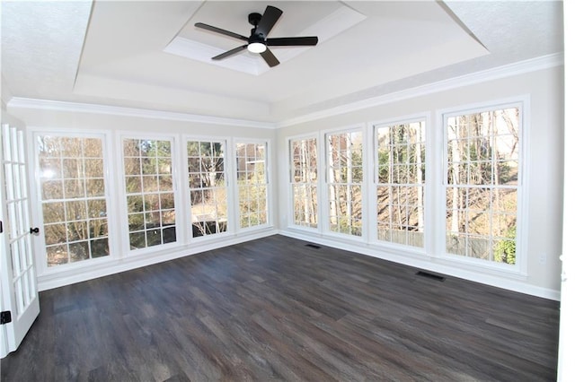 unfurnished sunroom with a wealth of natural light, a raised ceiling, and ceiling fan