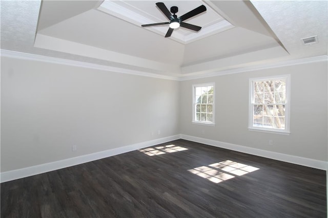 unfurnished room featuring ceiling fan, crown molding, dark hardwood / wood-style flooring, and a tray ceiling