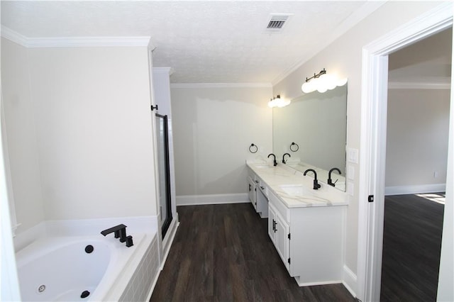 bathroom with crown molding, vanity, a bath, and wood-type flooring