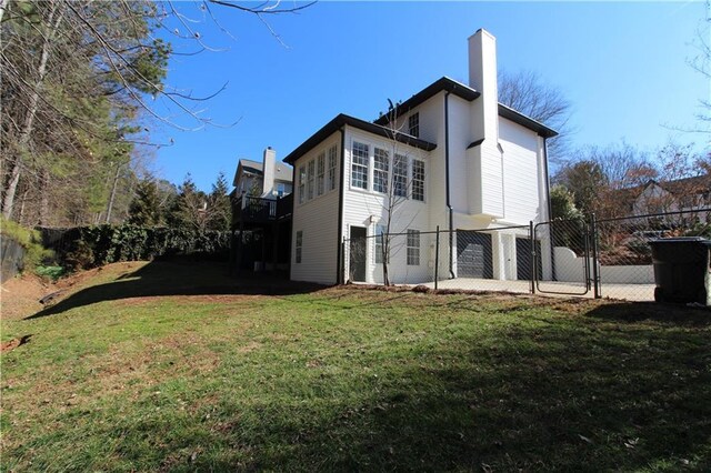 rear view of property with a yard