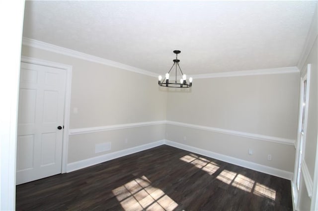 unfurnished room with ornamental molding, dark hardwood / wood-style floors, and an inviting chandelier