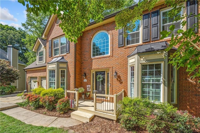 1313 Cobblestone Ln, Woodstock, GA 30189 - view of front of house with brick siding, concrete driveway, and a garage